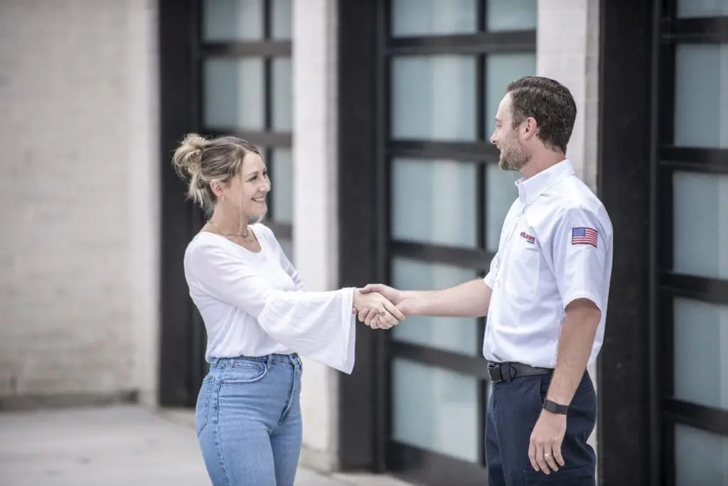 Welborn technician with happy customer shaking hands