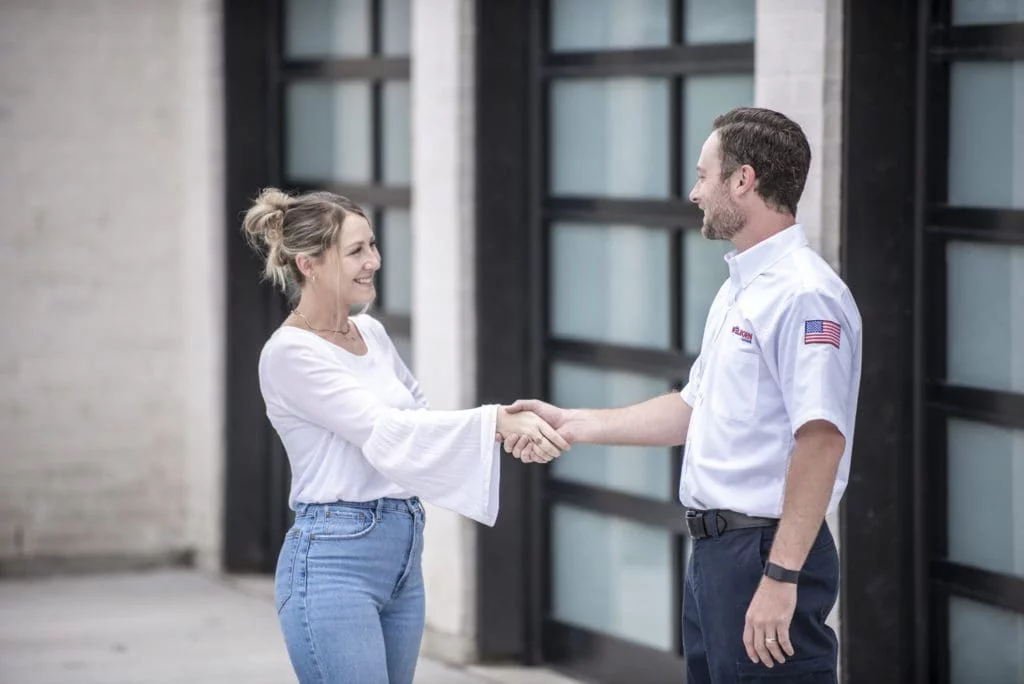 Welborn technician with happy customer shaking hands