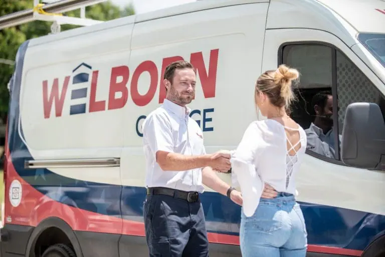 Tech next to welborn van shaking hands