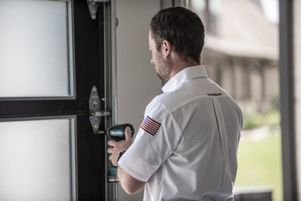 Welborn Technician Drilling Into Garage Door